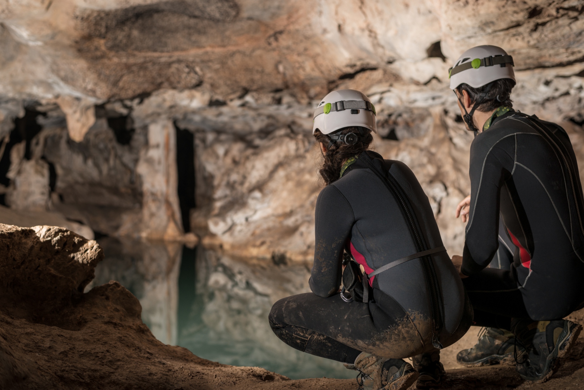 A pair of spelunker exploring a cave, the Grotta di Punta degli Stretti